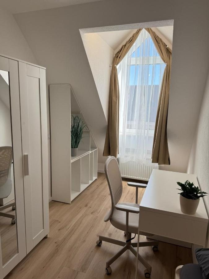 Bedroom with a desk by the window